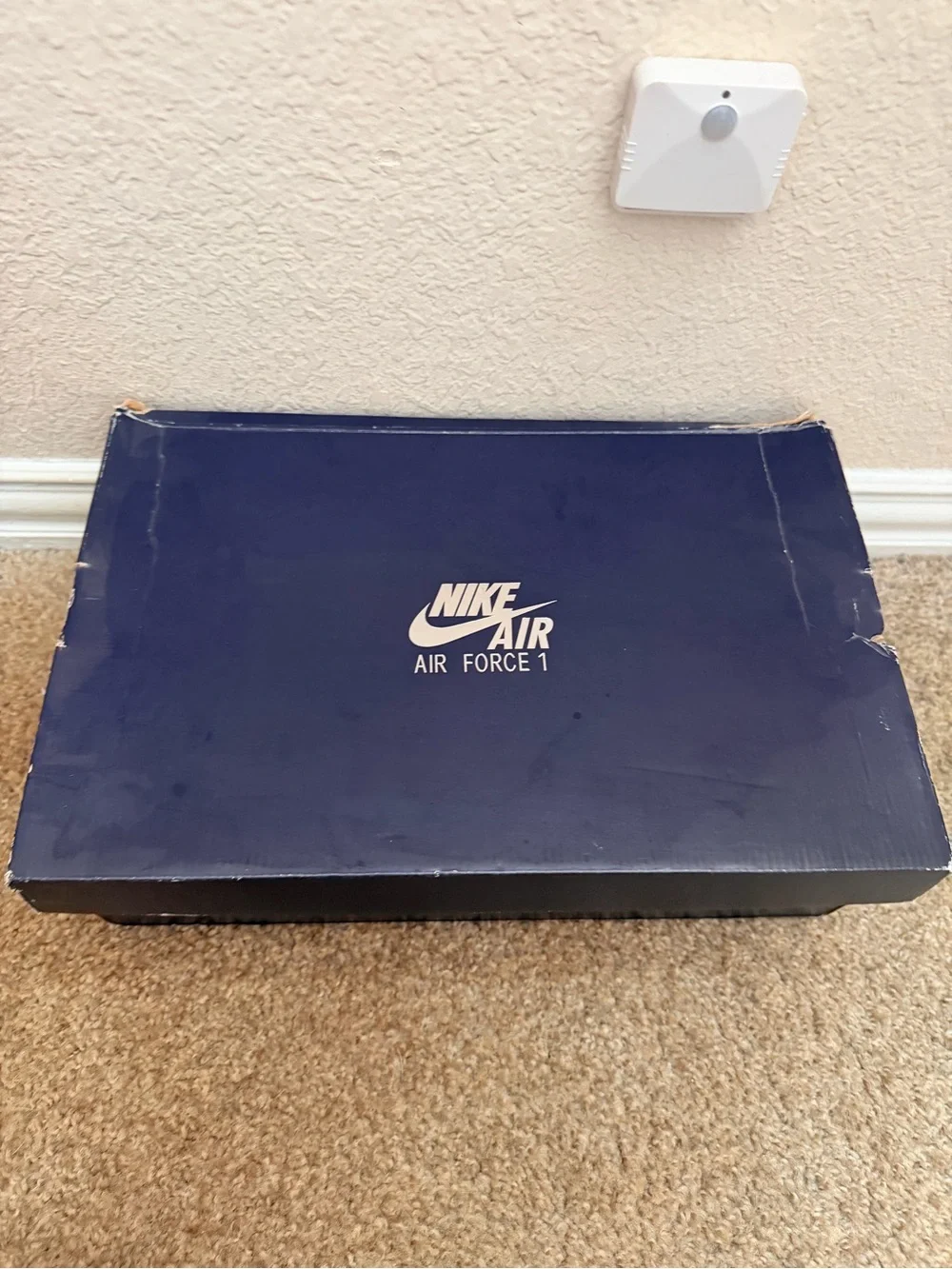 Shoebox on floor under wall sensor